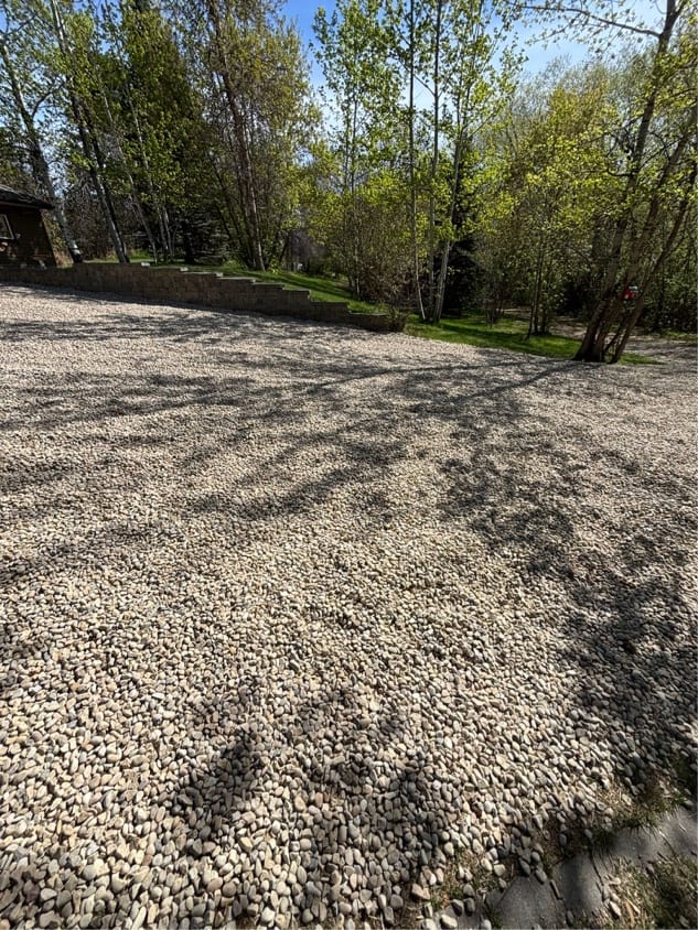Gravelled yard behind a block retaining wall